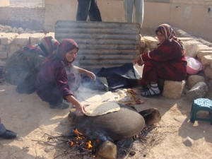 Women cook bread in Syria